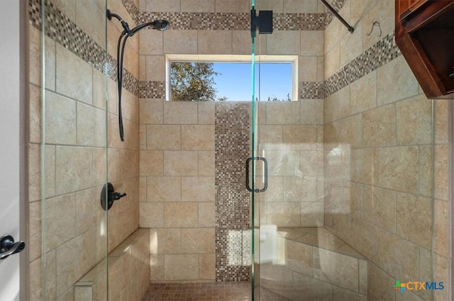 bathroom featuring a shower with door