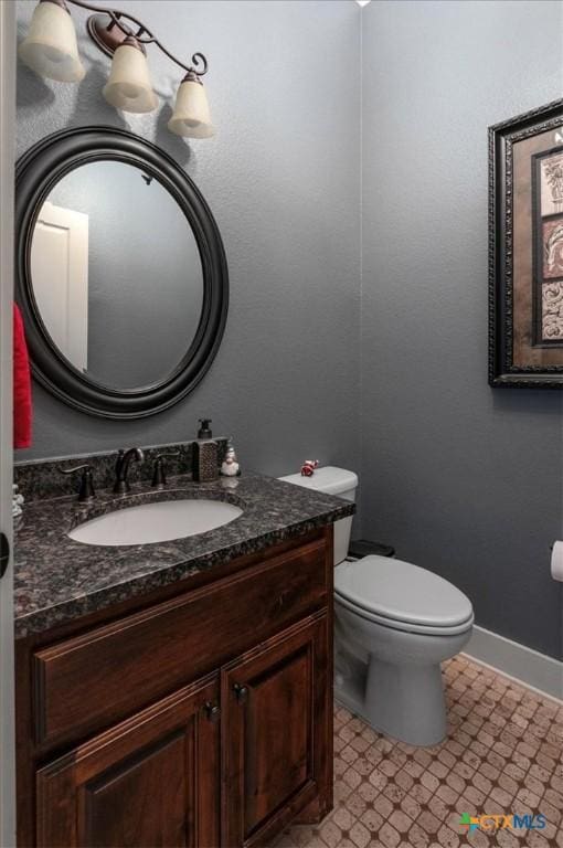 bathroom with toilet and vanity