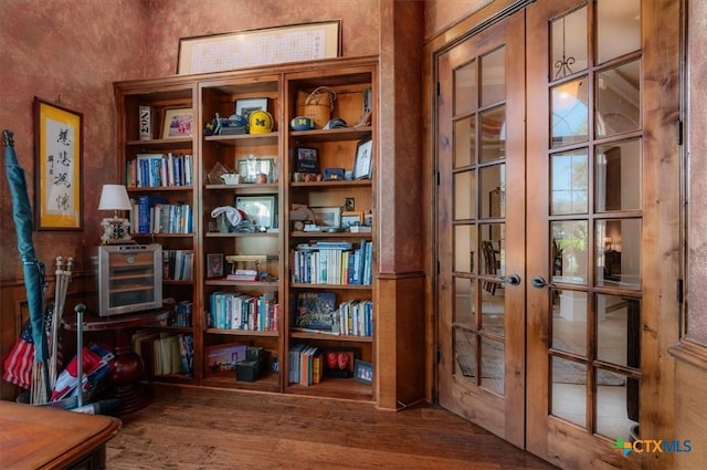 interior space with wood-type flooring and french doors