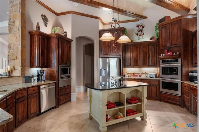 kitchen with decorative backsplash, dark stone countertops, stainless steel appliances, and pendant lighting