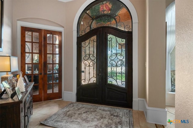 tiled foyer entrance featuring french doors