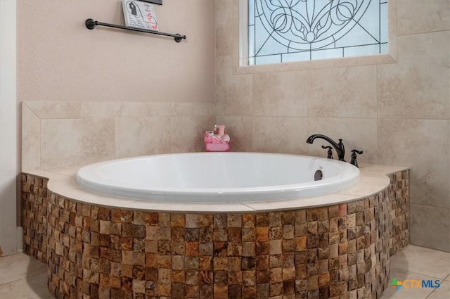 bathroom featuring tiled bath and tile patterned flooring