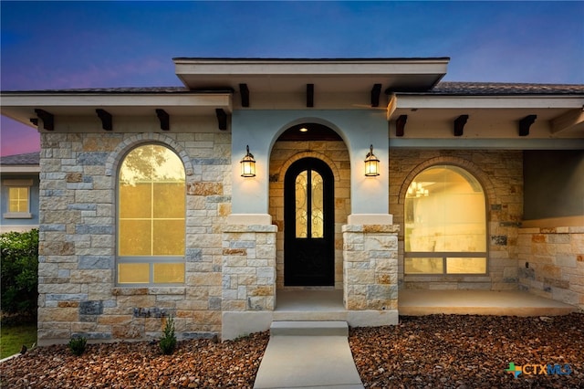 1607 Filtro, New Braunfels, TX 78132 - exterior entry at dusk featuring stone siding