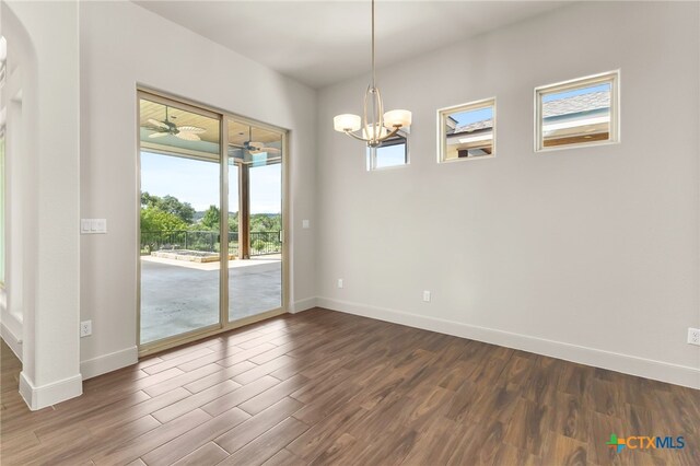 1607 Filtro, New Braunfels, TX 78132 - empty room featuring dark wood-style floors, a chandelier, and arched walkways