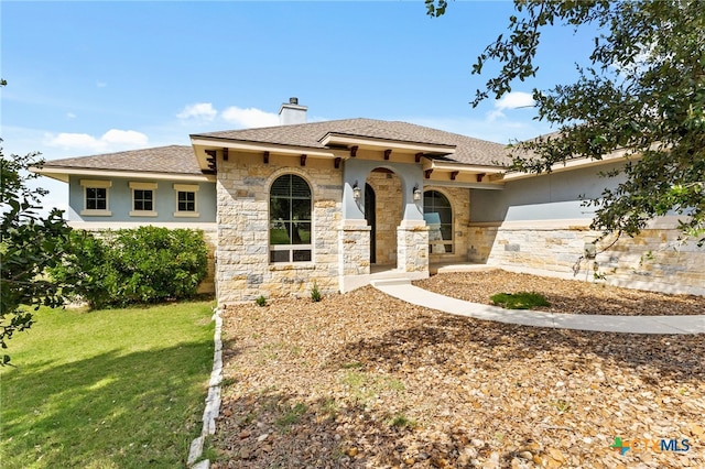 1607 Filtro, New Braunfels, TX 78132 - mediterranean / spanish-style home with a front yard, a chimney, stone siding, stucco siding, and a shingled roof