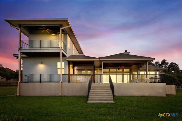 1607 Filtro, New Braunfels, TX 78132 - back of house at dusk featuring ceiling fan, a balcony, stairs, and a yard