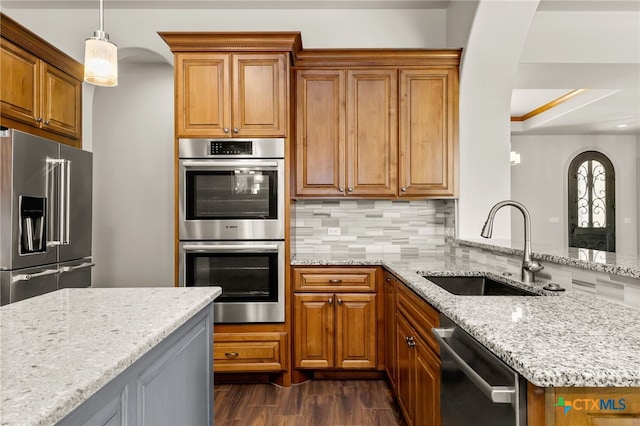 1607 Filtro, New Braunfels, TX 78132 - kitchen with stainless steel appliances, arched walkways, tasteful backsplash, light stone countertops, and dark wood finished floors