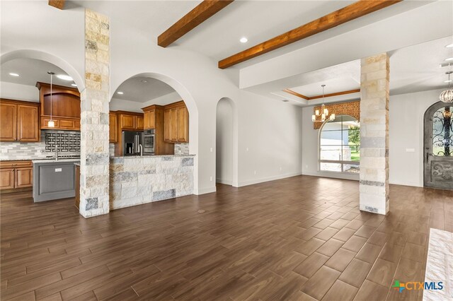 1607 Filtro, New Braunfels, TX 78132 - unfurnished living room with a chandelier, dark wood-type flooring, ornate columns, beamed ceiling, and recessed lighting
