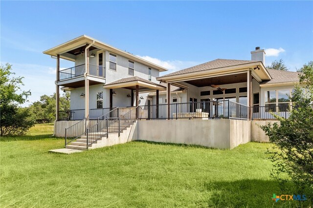 1607 Filtro, New Braunfels, TX 78132 - back of property featuring a balcony, a lawn, a chimney, ceiling fan, and stucco siding