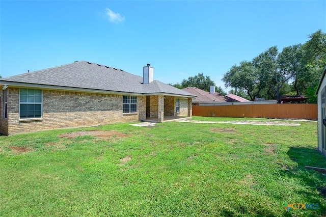 4901 Hammerstone Trl, Killeen, TX 76542 - back of house with brick siding, a patio, a chimney, and a shingled roof