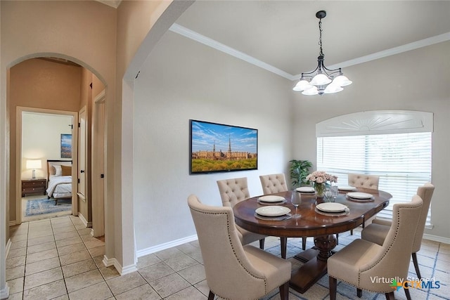 4901 Hammerstone Trl, Killeen, TX 76542 - dining area with arched walkways, light tile patterned floors, crown molding, a chandelier, and baseboards