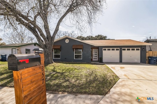 single story home featuring an attached garage, concrete driveway, and a front yard