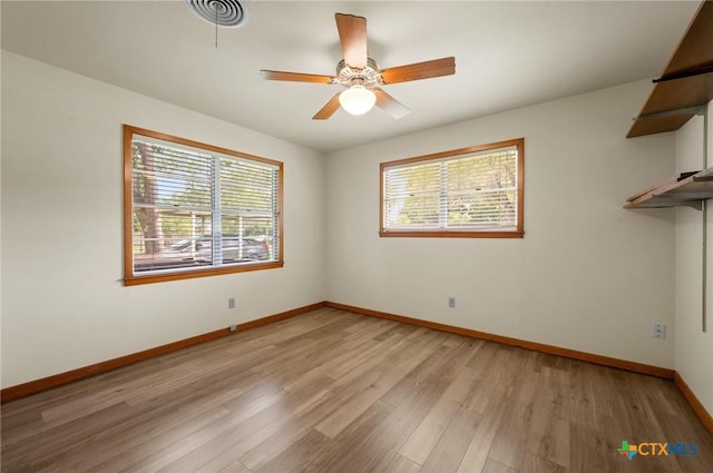 201 Hillcrest Dr, Luling, TX 78648 - unfurnished room featuring plenty of natural light, light wood-type flooring, baseboards, and a ceiling fan