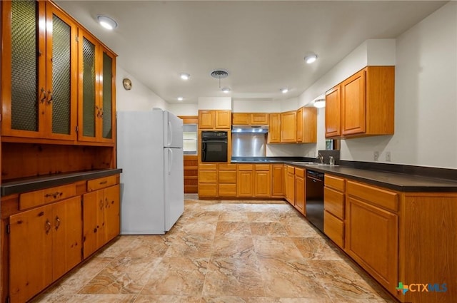 201 Hillcrest Dr, Luling, TX 78648 - kitchen with black appliances, under cabinet range hood, dark countertops, glass insert cabinets, and recessed lighting