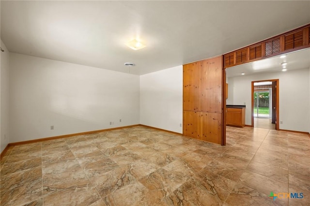 201 Hillcrest Dr, Luling, TX 78648 - spare room featuring light stone finish flooring and baseboards