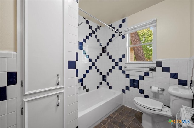 201 Hillcrest Dr, Luling, TX 78648 - full bathroom with tile walls, toilet, a wainscoted wall, and bathtub / shower combination