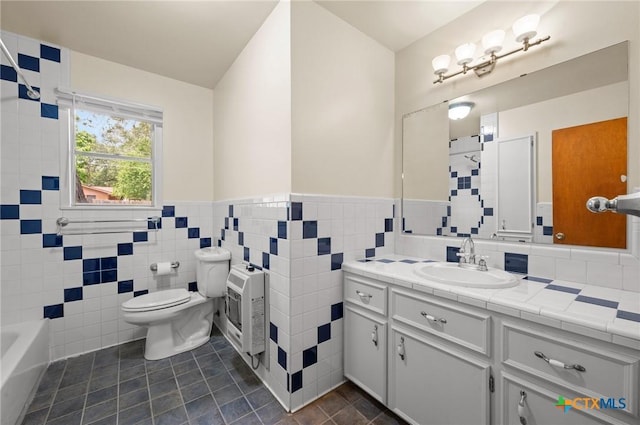 201 Hillcrest Dr, Luling, TX 78648 - bathroom featuring vanity, a tub, toilet, tile patterned flooring, and a wainscoted wall