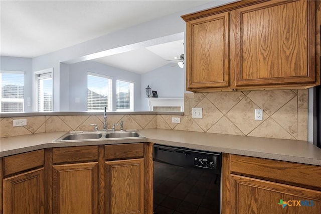 kitchen with tasteful backsplash, lofted ceiling, black dishwasher, sink, and ceiling fan