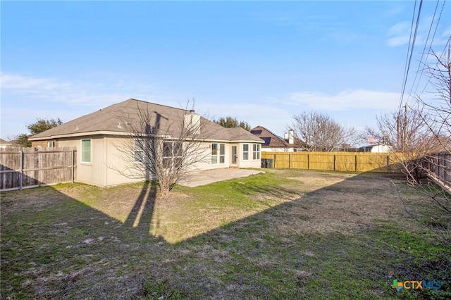 rear view of property with a patio and a lawn