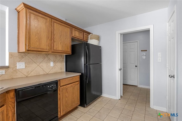 kitchen featuring backsplash, black appliances, and light tile patterned flooring