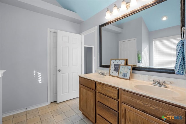 bathroom featuring lofted ceiling, vanity, and tile patterned flooring