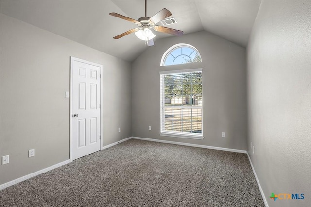 carpeted spare room with vaulted ceiling and ceiling fan