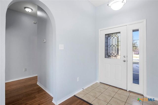 entryway with light tile patterned flooring