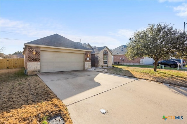 ranch-style house with a garage and a front lawn