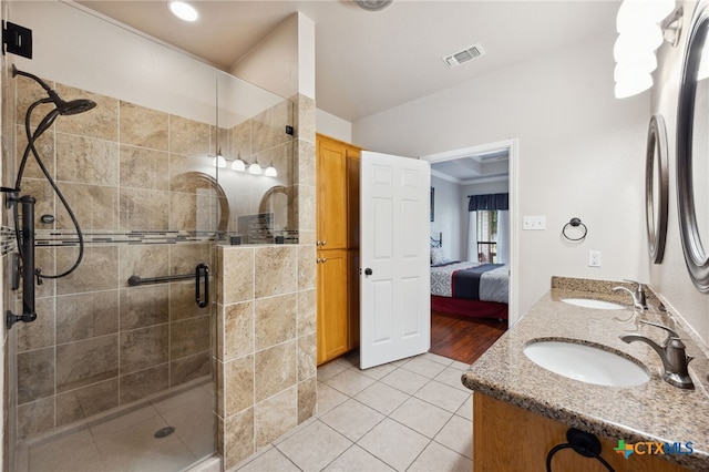 460 Shayla Ln, Canyon Lake, TX 78133 - bathroom featuring double vanity, a shower stall, tile patterned flooring, and connected bathroom