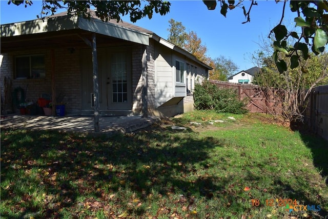 exterior space with a lawn and a patio area