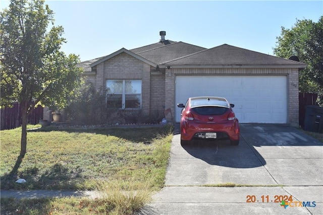 ranch-style home with a front lawn and a garage