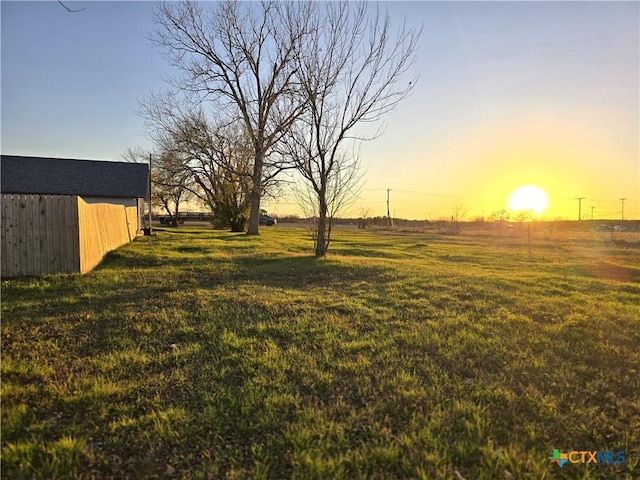 view of yard at dusk