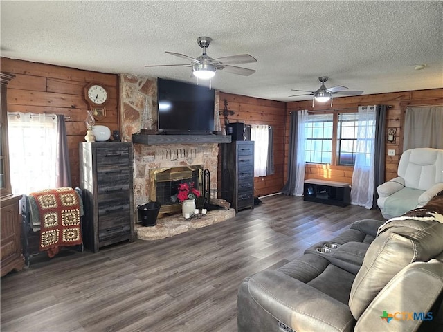 living room with a wealth of natural light, wooden walls, and dark hardwood / wood-style flooring