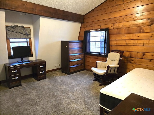 interior space with dark colored carpet, a textured ceiling, lofted ceiling with beams, and wooden walls