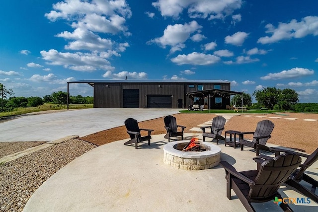 13852 Knob Hill Rd, Rogers, TX 76569 - view of patio / terrace with an outdoor fire pit and a detached garage