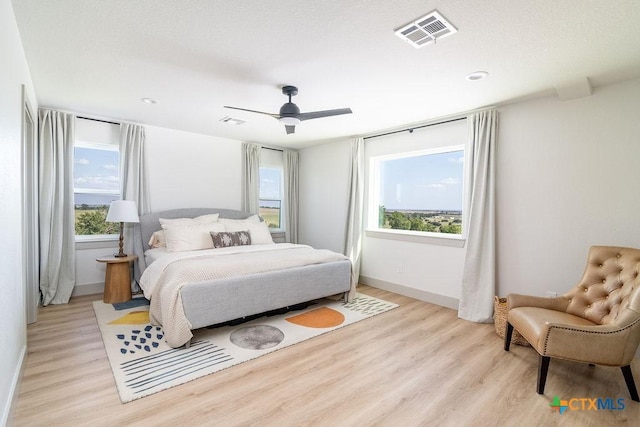 13852 Knob Hill Rd, Rogers, TX 76569 - bedroom with light wood finished floors, multiple windows, and ceiling fan