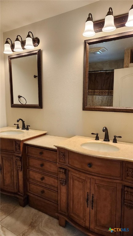full bath featuring tile patterned floors, visible vents, and vanity