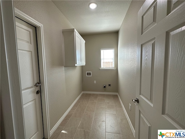 washroom with a textured ceiling, hookup for a washing machine, electric dryer hookup, and cabinets