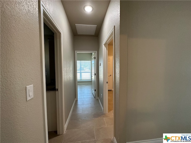 hallway featuring light tile patterned flooring