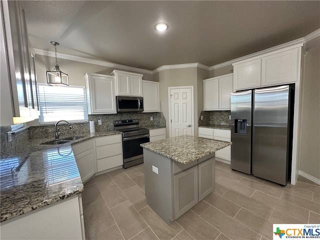 kitchen featuring stainless steel appliances, a center island, white cabinets, sink, and decorative light fixtures