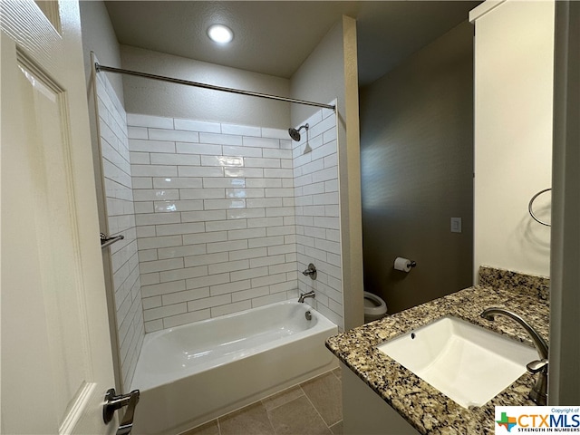 full bathroom with toilet, tiled shower / bath combo, vanity, and tile patterned floors