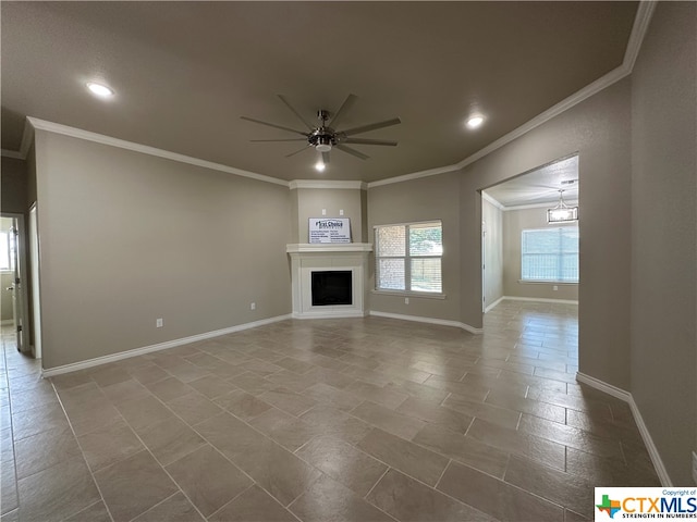 unfurnished living room with ceiling fan with notable chandelier and crown molding