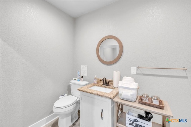 735 Slawson Ln, Killeen, TX 76542 - half bath featuring toilet, a textured wall, vanity, and baseboards
