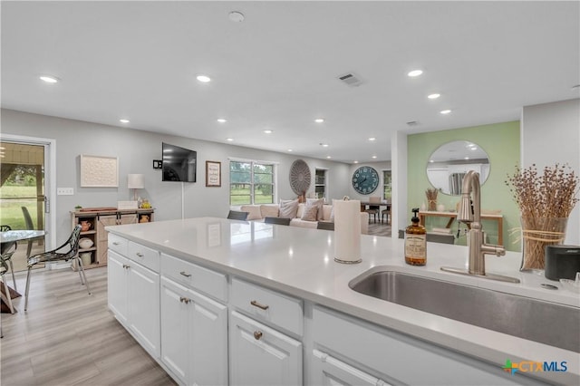 735 Slawson Ln, Killeen, TX 76542 - kitchen featuring recessed lighting, white cabinets, a sink, light countertops, and light wood-style floors