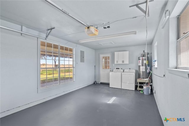 garage with a garage door opener, washer and clothes dryer, electric panel, and water heater