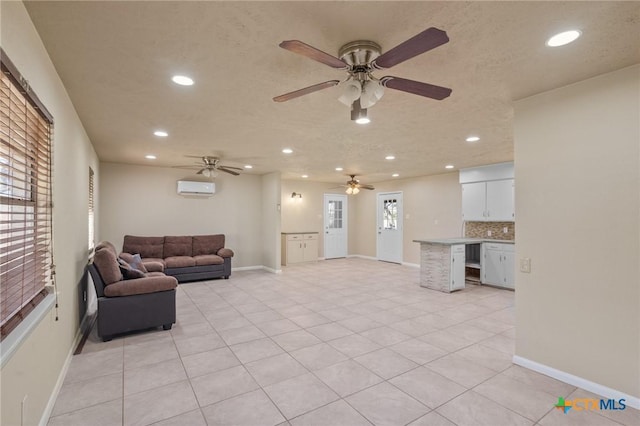 tiled living room with a wall unit AC and a textured ceiling