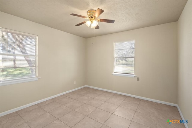 unfurnished room with light tile patterned floors, a textured ceiling, and ceiling fan