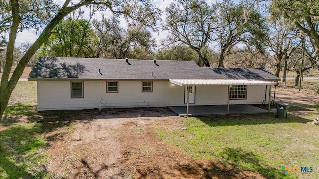 rear view of property with a patio area and a lawn