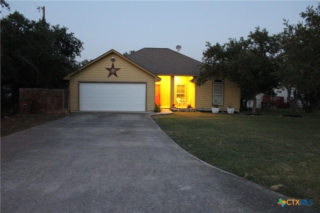 ranch-style house featuring a garage, concrete driveway, a front lawn, and fence