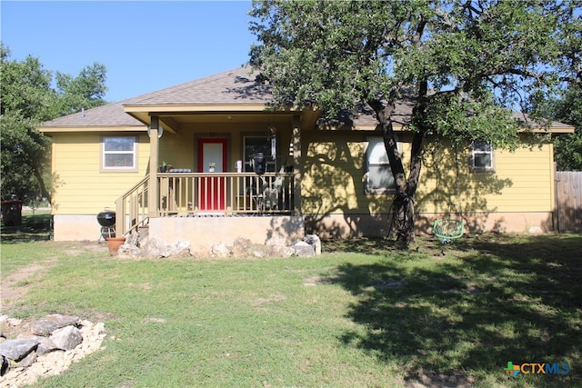 view of front of home with a porch and a front yard